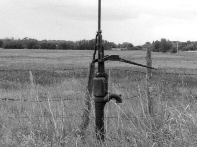 Typical hand pump inserted into a well cribbing