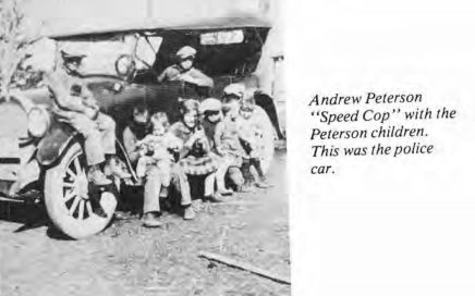 Andrew Peterson with his children and police car